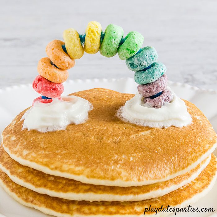 Who says St Patrick's Day gets all the fun rainbow crafts? My preschool son loved to make these easy DIY rainbow cupcake toppers just as much as he enjoyed seeing them on his pancakes with a whipped cream cloud. And I loved that they are inexpensive, using fruit loops cereal, pipe cleaners, and a simple trick to make them food safe. #crafts #rainbow #kidscrafts