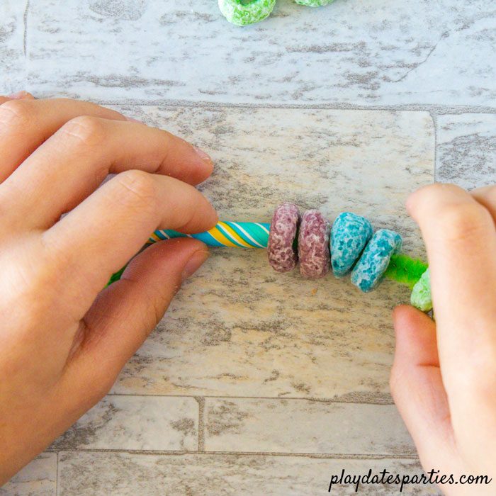 Making rainbow cupcake toppers Step 3: Add paper straws to the ends