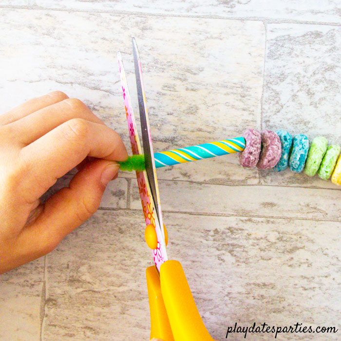 Making rainbow cupcake toppers step 4: trim the extra pipe cleaner ends