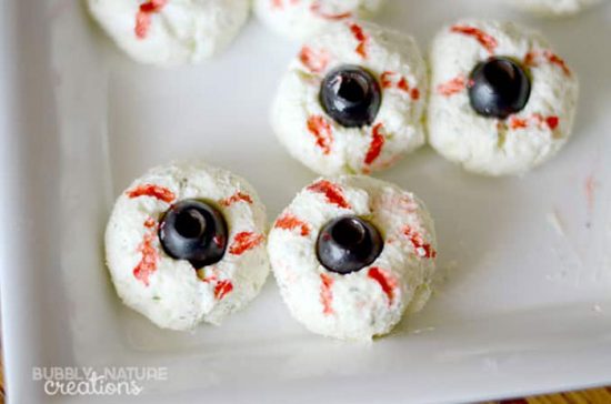 Halloween party food: cheese balls that look like eyeballs on a platter