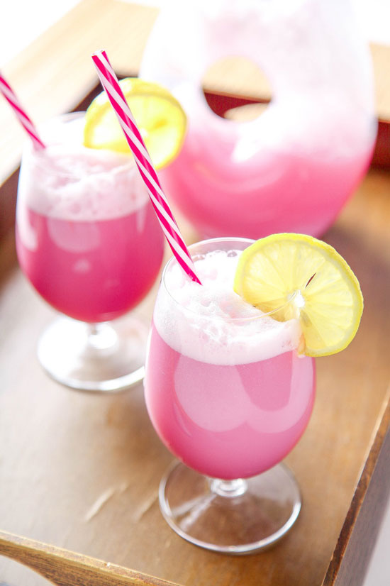 pink raspberry sherbet punch with pink straws and lemon slices