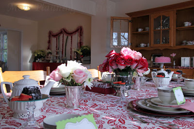 formal dining table display with red pink and white roses
