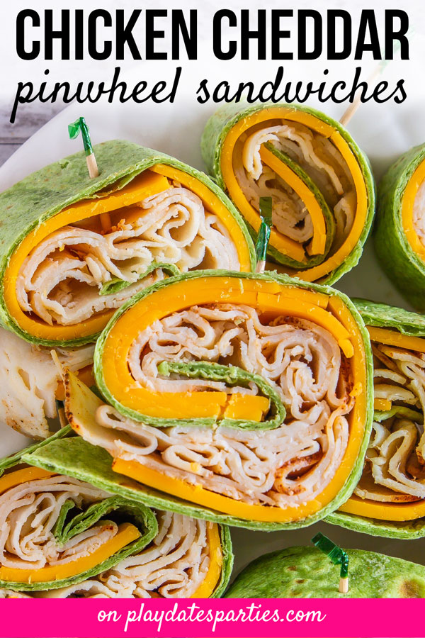 close up of a plate full of chicken cheddar pinwheel sandwiches