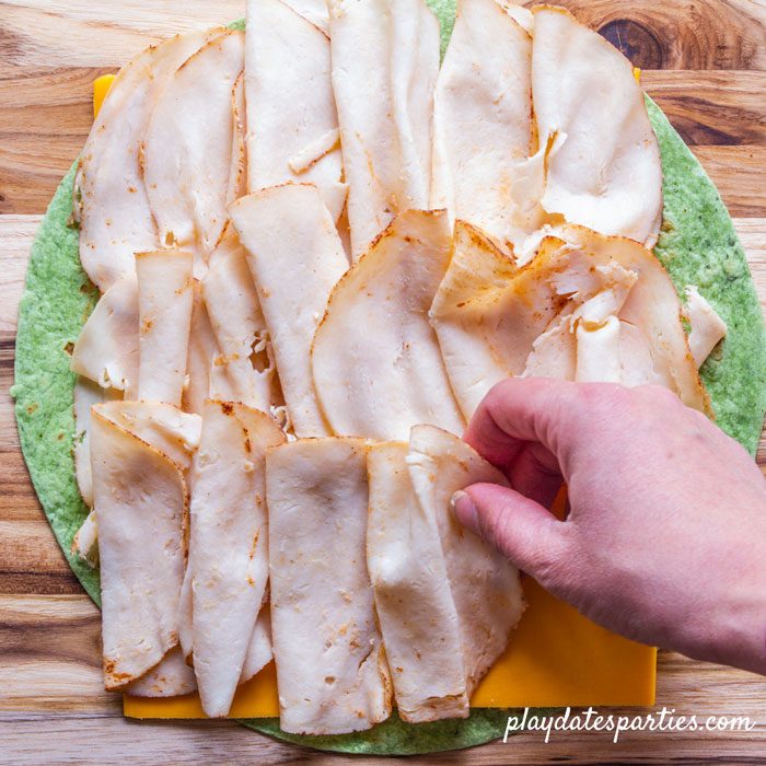step 3 - arranging deli chicken on the wrap
