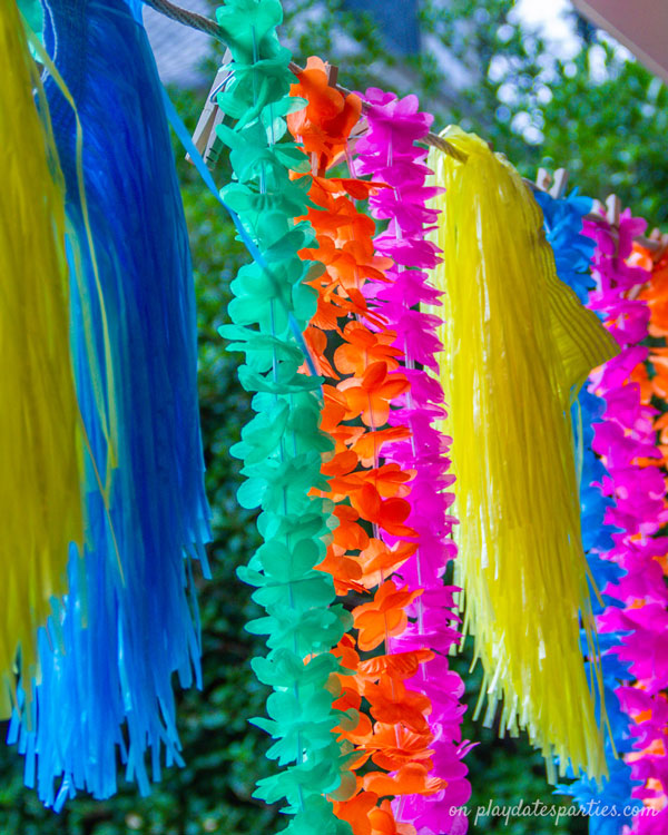 Colorful grass skirts and Hawaiian leis used as decorations for a luau party