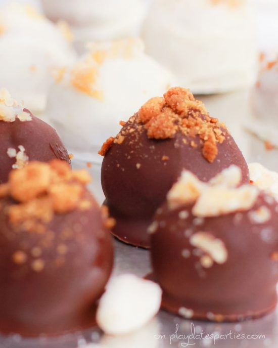 chocolate pumpkin truffles garnished with gingersnaps and candied ginger