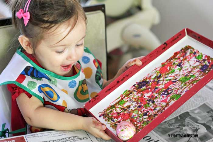 toddler decorating easter eggs