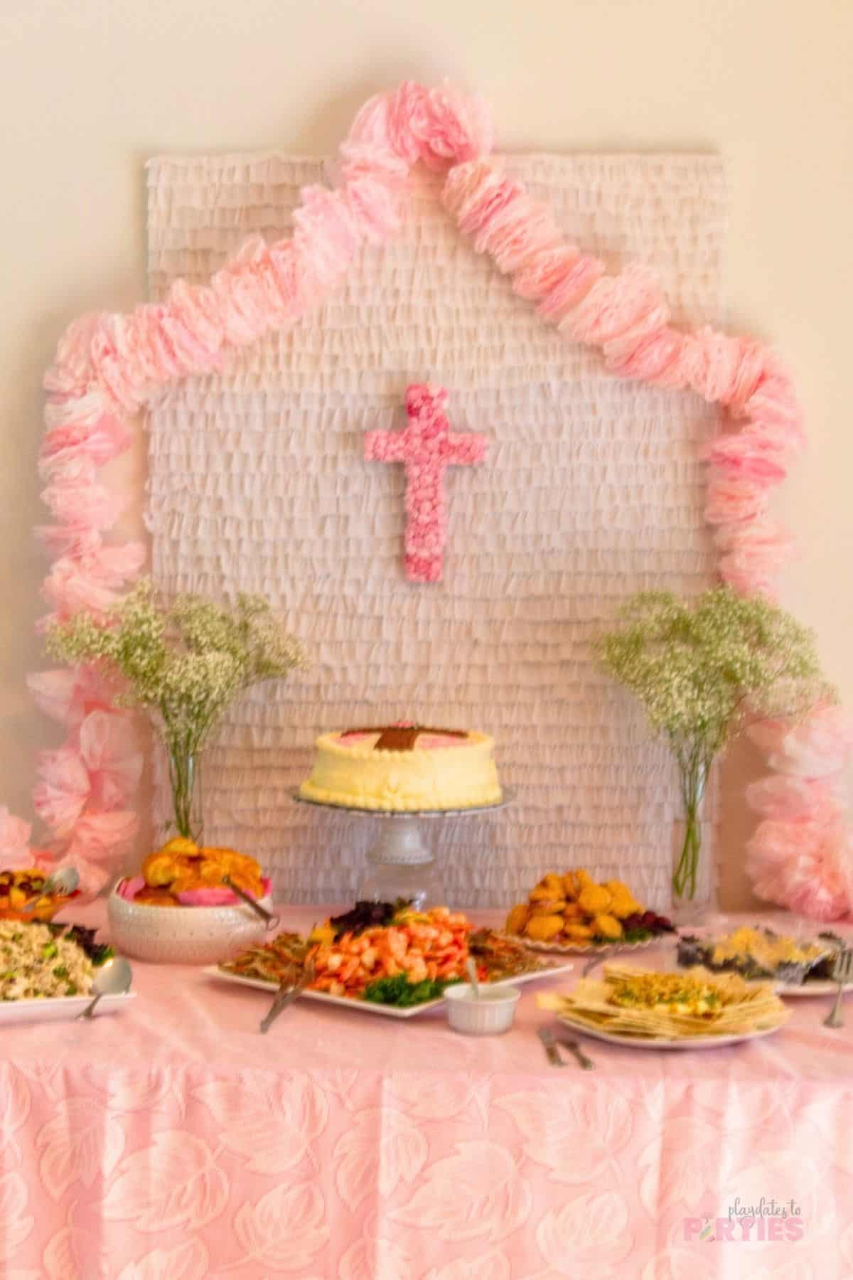 A frilly pink buffet for a baby girl baptism reception.