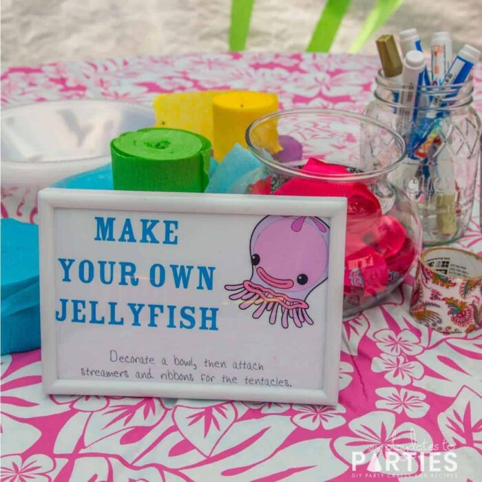 make your own jellyfish station with crepe paper streamers, ribbon, and paint pens