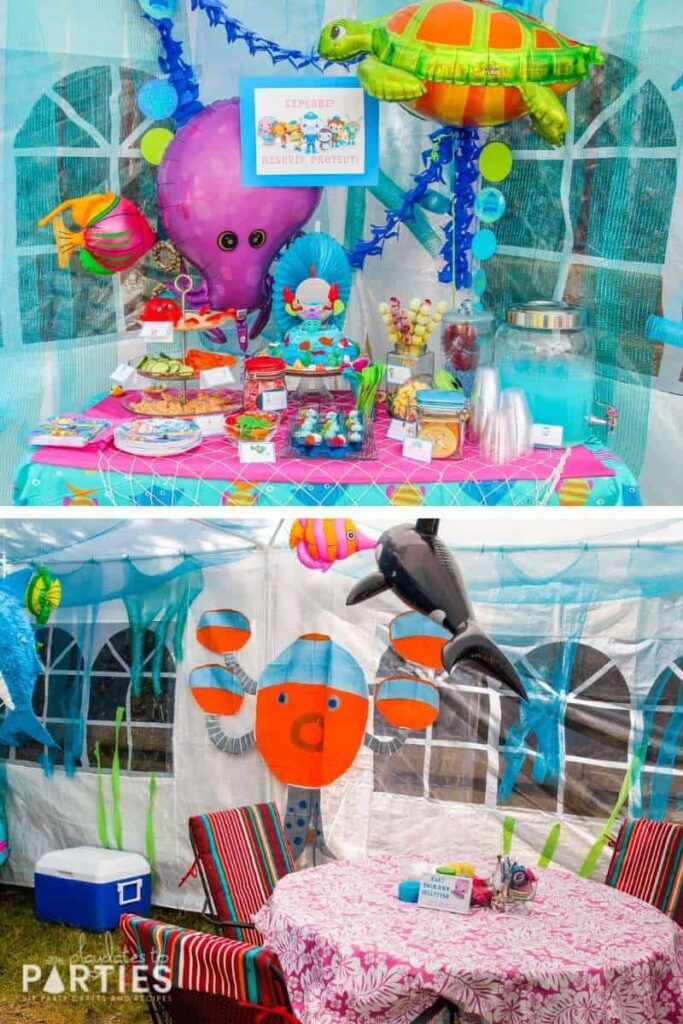 inside of a party tent decorated with ocean decor, including several sea creature balloons