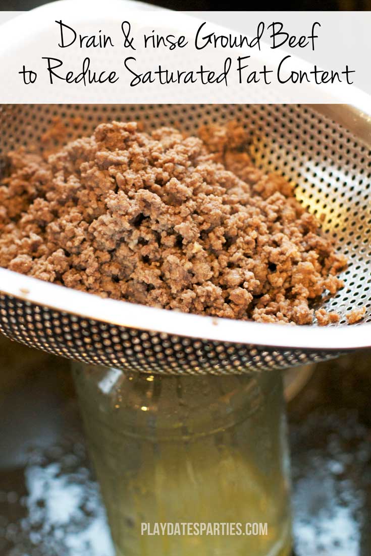 Cooked ground beef draining in a colander with a text overlay: Dran & rinse ground beef to reduce saturated fat content.