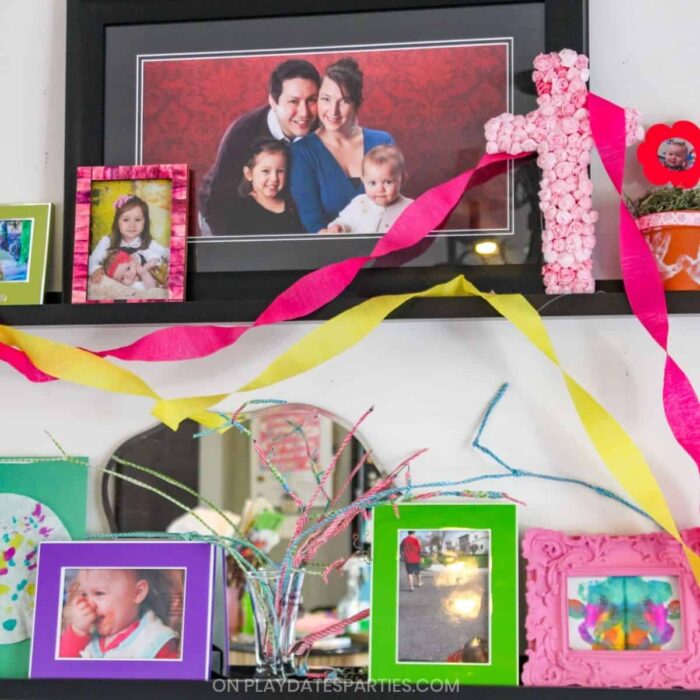two wall ledges filled with colorful frames that have family photos and kids artwork