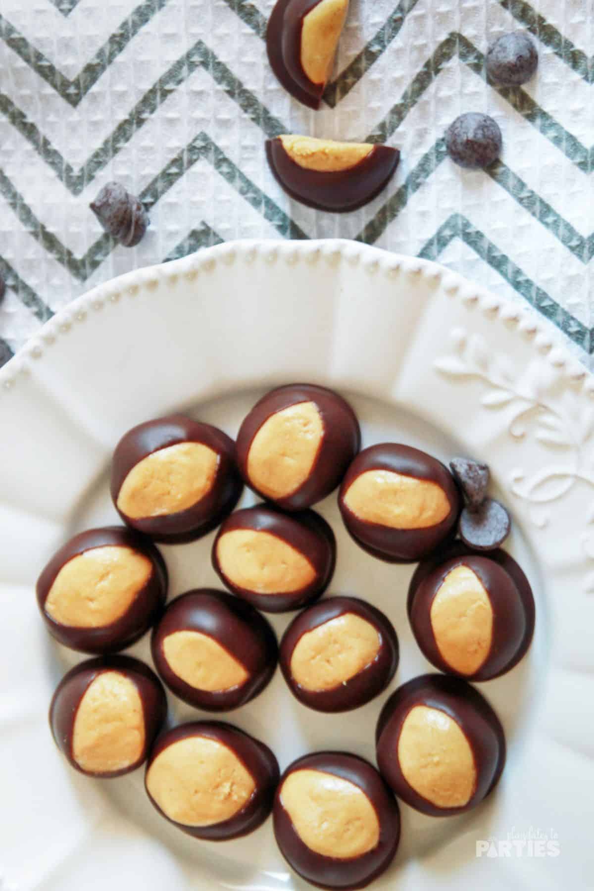 Peanut Butter Balls with Chocolate on a white plate.