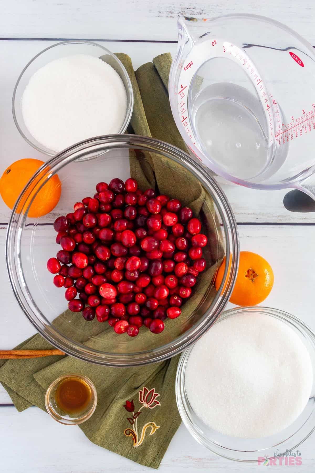 Ingredients for sugared cranberries with orange and vanilla.