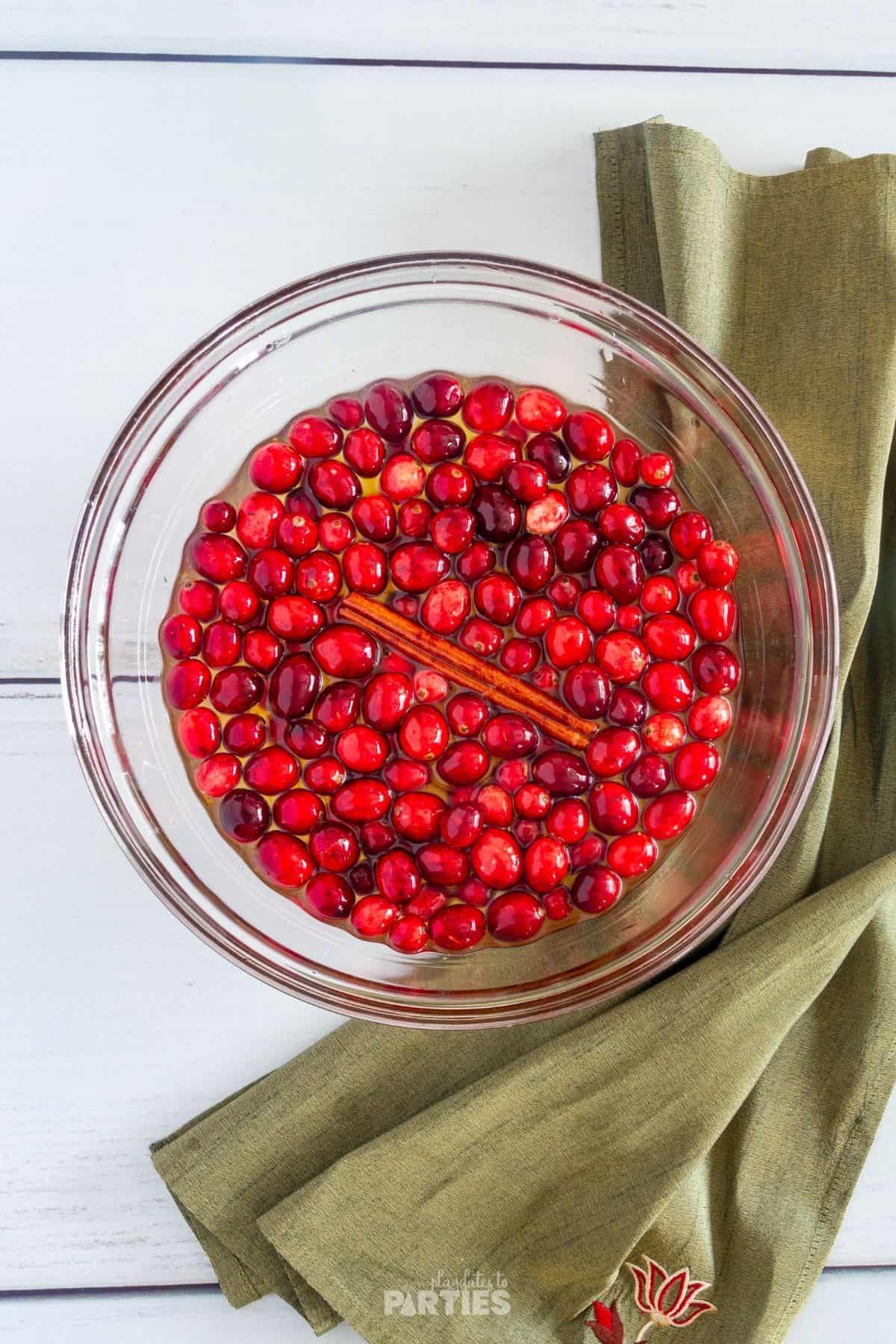 Soaking cranberries in simple syrup.