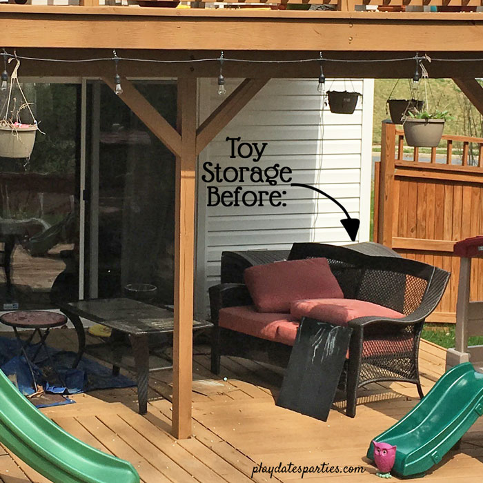 Outdoor toy storage in a resin box on a deck.