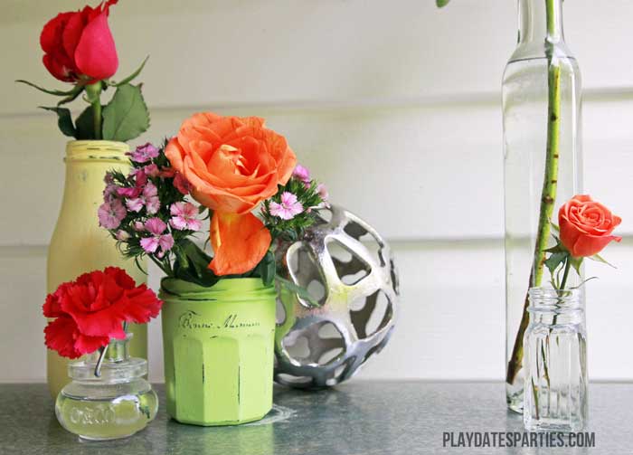 Old glass jars make perfect vases when painted with chalk paint and distressed. 