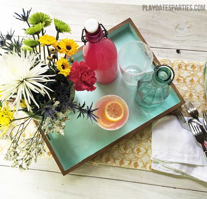 An unfinished tray gets a modern makeover with a natural stain on the outside and blue chalk paint on the inside.