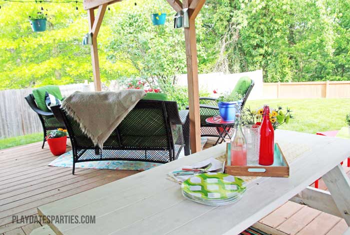 Take a look at this backyard renovation, with loads of DIY projects to get your backyard ready for summer entertaining. Projects include a homemade pallet bar, painted patio cushions, painted patio furniture, a DIY privacy screen, outdoor lighting and more!