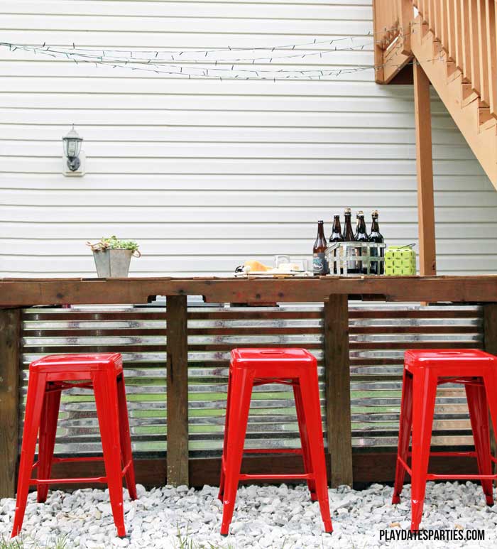 Take a look at this backyard renovation, with loads of DIY projects to get your backyard ready for summer entertaining. Projects include a homemade pallet bar, painted patio cushions, painted patio furniture, a DIY privacy screen, outdoor lighting and more!