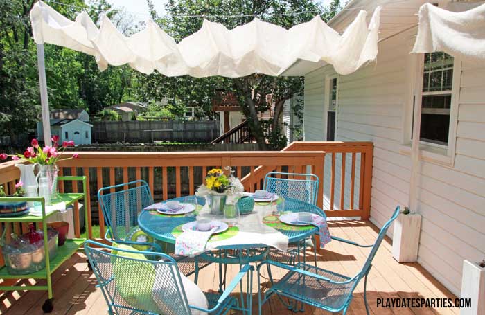 Take a look at this backyard renovation, with loads of DIY projects to get your backyard ready for summer entertaining. Projects include a homemade pallet bar, painted patio cushions, painted patio furniture, a DIY privacy screen, outdoor lighting and more!