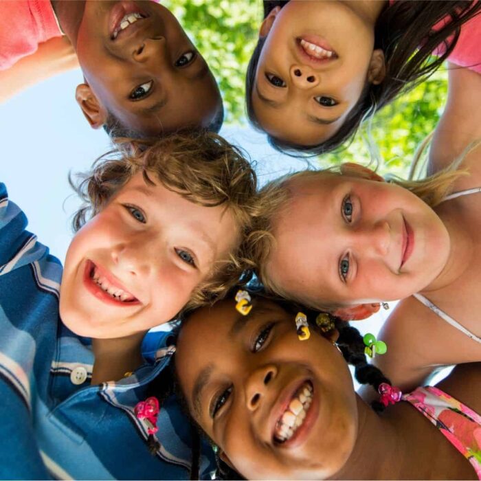 happy children smiling down from overhead