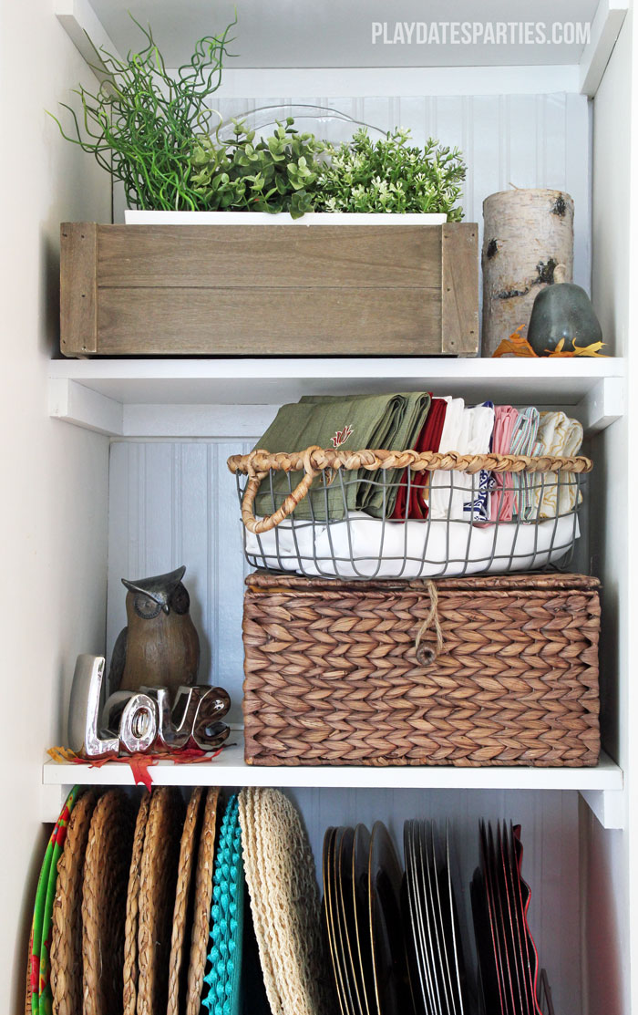 Narrow built-in shelves get a makeover to provide storage that is both functional as well as beautiful.
