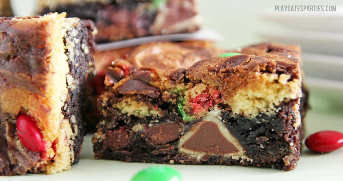 Double decker triple stuffed brownies combine swirled layers of chocolate brownie and yellow cake stuffed with Hershey's kisses, Hugs, and M&Ms.