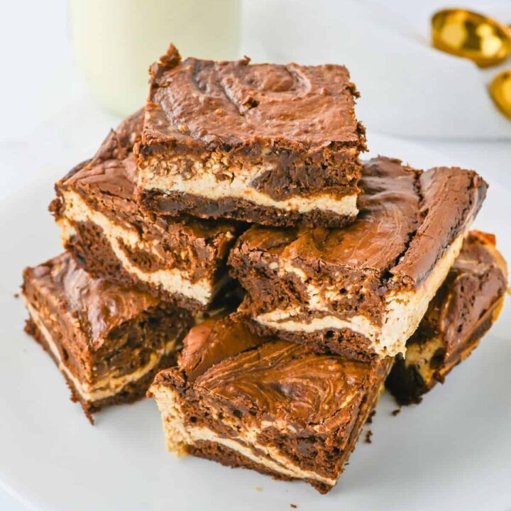 Java eggnog brownies stacked on a white plate.