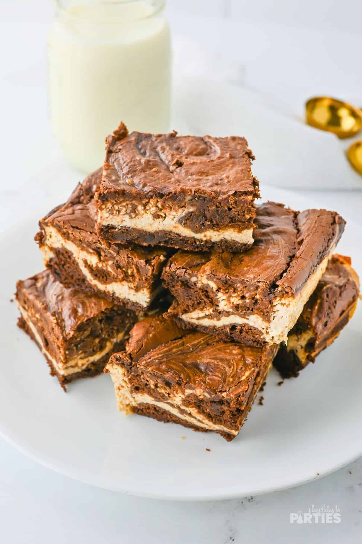 Java eggnog brownies stacked on a white plate.