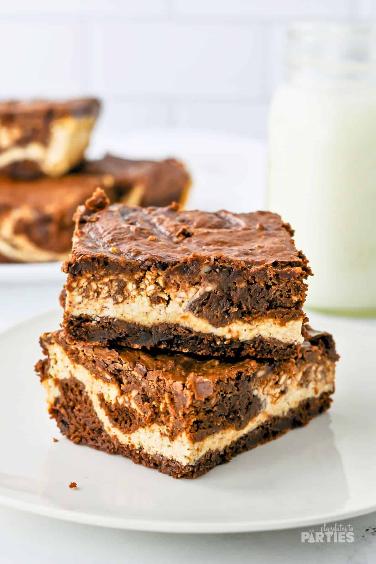 Two swirled Christmas brownies on a white plate.