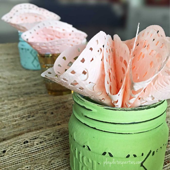 These 3-minute paper doily flowers are incredibly easy and make a beautiful impact when put together as a single flower or as a table-length centerpiece.