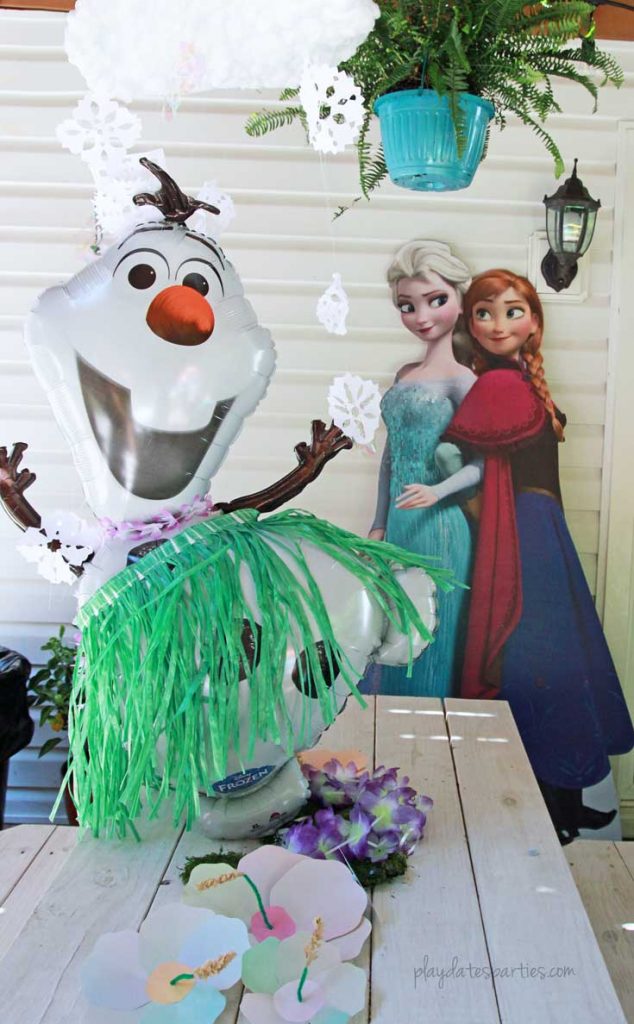 This stunning Frozen luau party is full of easy DIY projects and simple tips that you can absolutely recreate for a special little girl in your life. Including: an Olaf snow flurry, Olaf jello cups, a fake snow beach, a purple and blue ice cream cake, and lots of snowflakes everywhere!