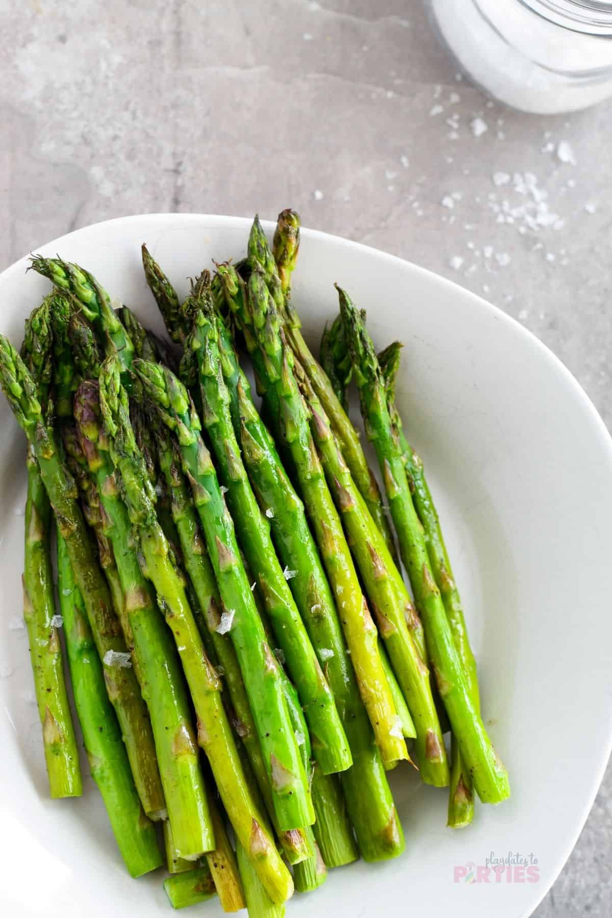 A pile of roasted asparagus spears ready to eat.
