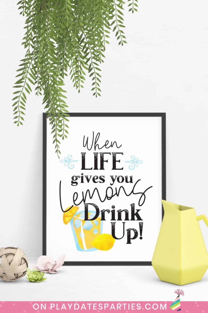 art print in a black frame that says when life gives you lemons drink up with a yellow pitcher and other decor around it