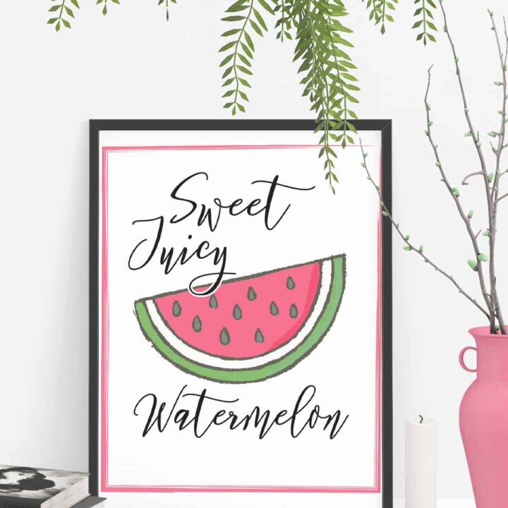Art print on a table that has a picture of a wedge of watermelon with the words sweet juicy watermelon