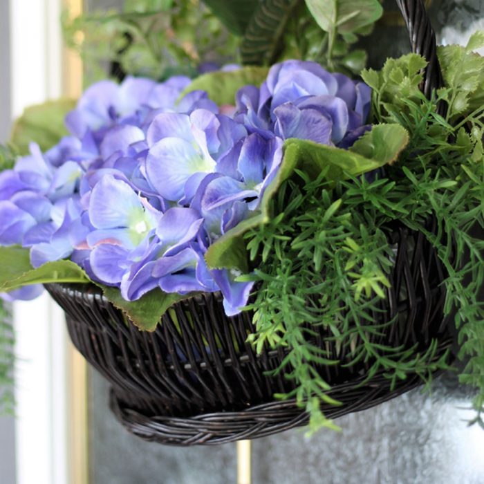 Tired of the same old wreath shape on your front door? Try a basket wreath instead! Start off with this beautiful hydrangea wreath for summer and find out how to change it up for every season!