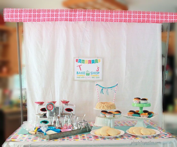 Turn your island into a bake shop window with a DIY backdrop frame and plenty of ready-to-decorate cupcakes and cookies.