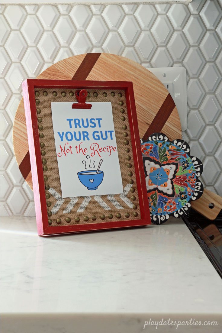 "Trust Your Gut Not the Recipe" print by From Play Dates to Parties. Shown on faux marble quartz countertops in this gorgeous white kitchen reveal.