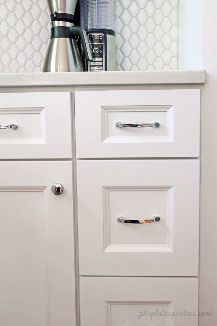 Big style can fit in #small spaces! Take a look at the before and after of this small white kitchen renovation. Including faux marble quartz countertops, #DIY wood shelves, light wood floors, and modern white tile for a clean and classic home #design.