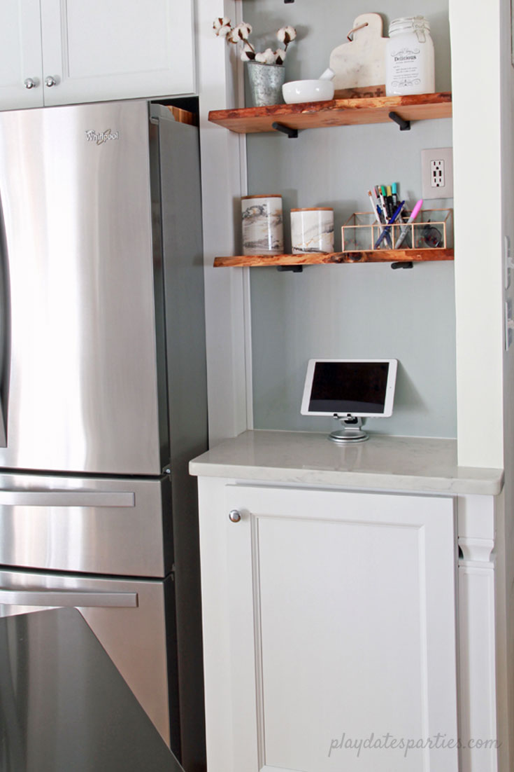 Big style can fit in #small spaces! Take a look at the before and after of this small white kitchen renovation. Including faux marble quartz countertops, #DIY wood shelves, light wood floors, and modern white tile for a clean and classic home #design.