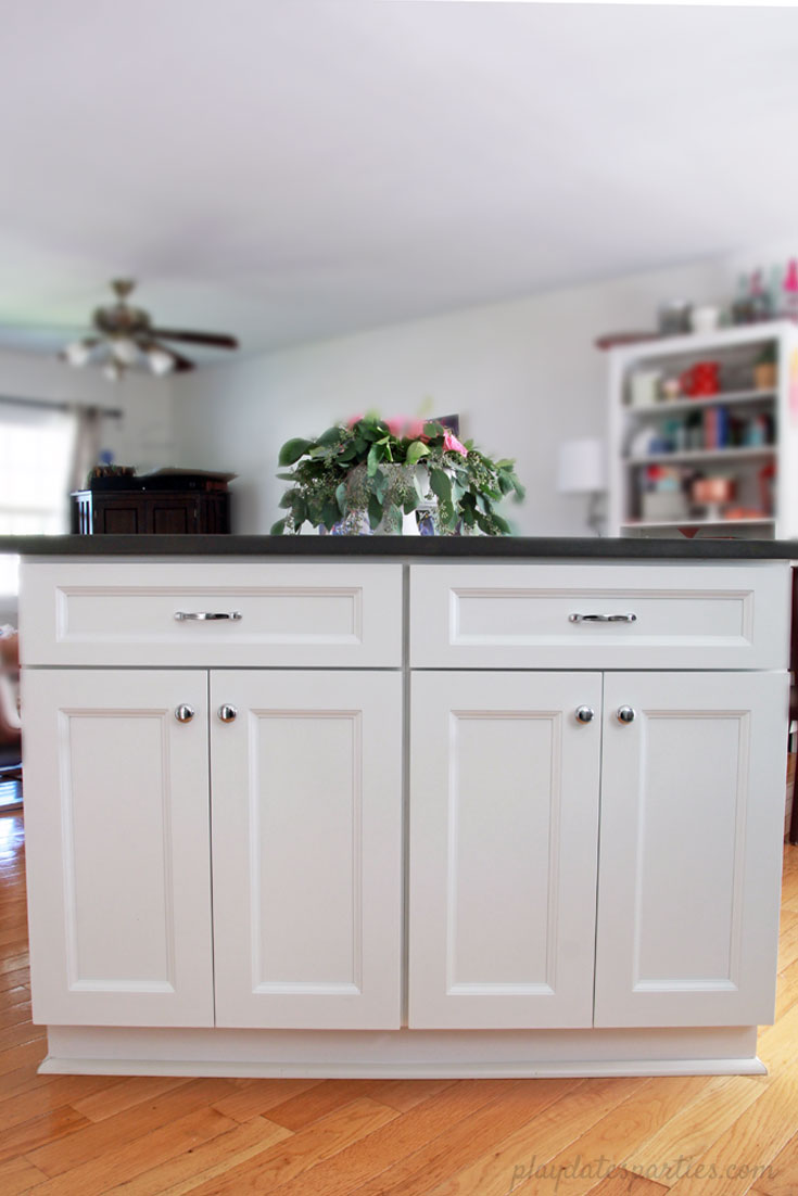 Big style can fit in #small spaces! Take a look at the before and after of this small white kitchen renovation. Including faux marble quartz countertops, #DIY wood shelves, light wood floors, and modern white tile for a clean and classic home #design.