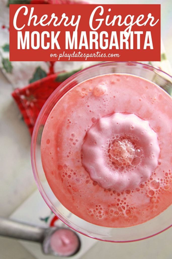 This cherry ginger mock margarita recipe is the perfect Christmas party drink for kids to enjoy. Half drink half dessert, big and little kids will love the bright color, fruity flavor, and sherbet wreath in the center of the drink. #virgin #cocktails #kids #holidayrecipes #drinkrecipes #christmas #holidaysweettreats