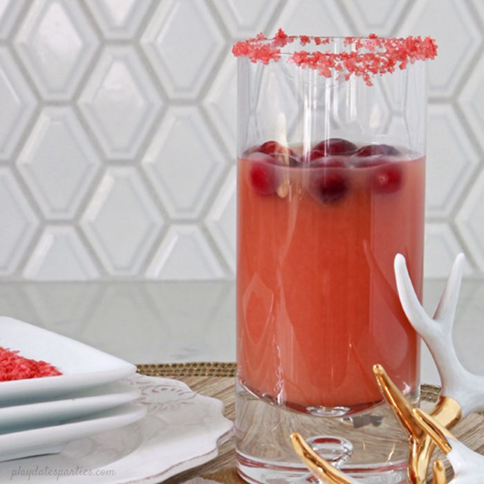 The Salty Dog cocktail gets a holiday update into the Salty Rudolph Cocktail, with cranberry, orange, the classic salted rim, and a surprising twist at the end. #Christmas #drinks #recipes