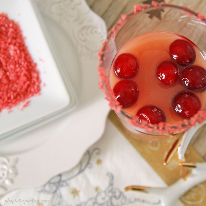 The Salty Dog cocktail gets a holiday update into the Salty Rudolph Cocktail, with cranberry, orange, the classic salted rim, and a surprising twist at the end. #Christmas #drinks #recipes