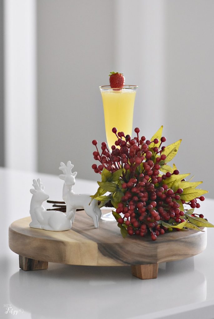 Mimosas on a wood board with berries and reindeer