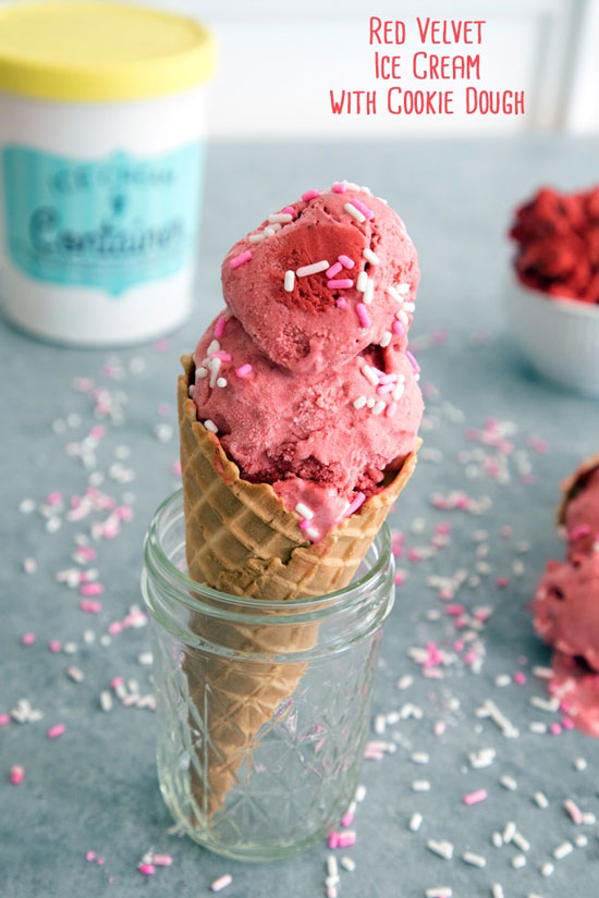 A waffle cone with red velvet ice cream and sprinkles