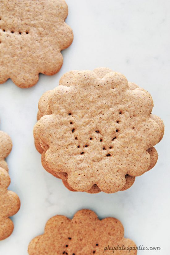 Flower-shaped homemade graham crackers with letters pierced into them