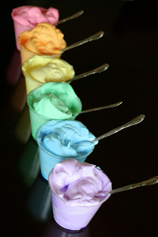 Cups of rainbow colored foam dough made with shaving cream