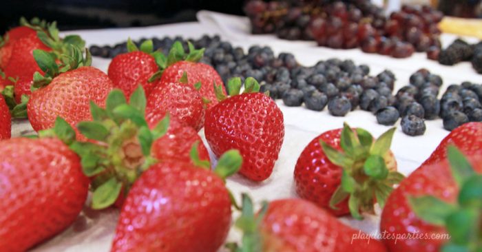 Image of meal prep with washed fruit and berries drying on paper towels